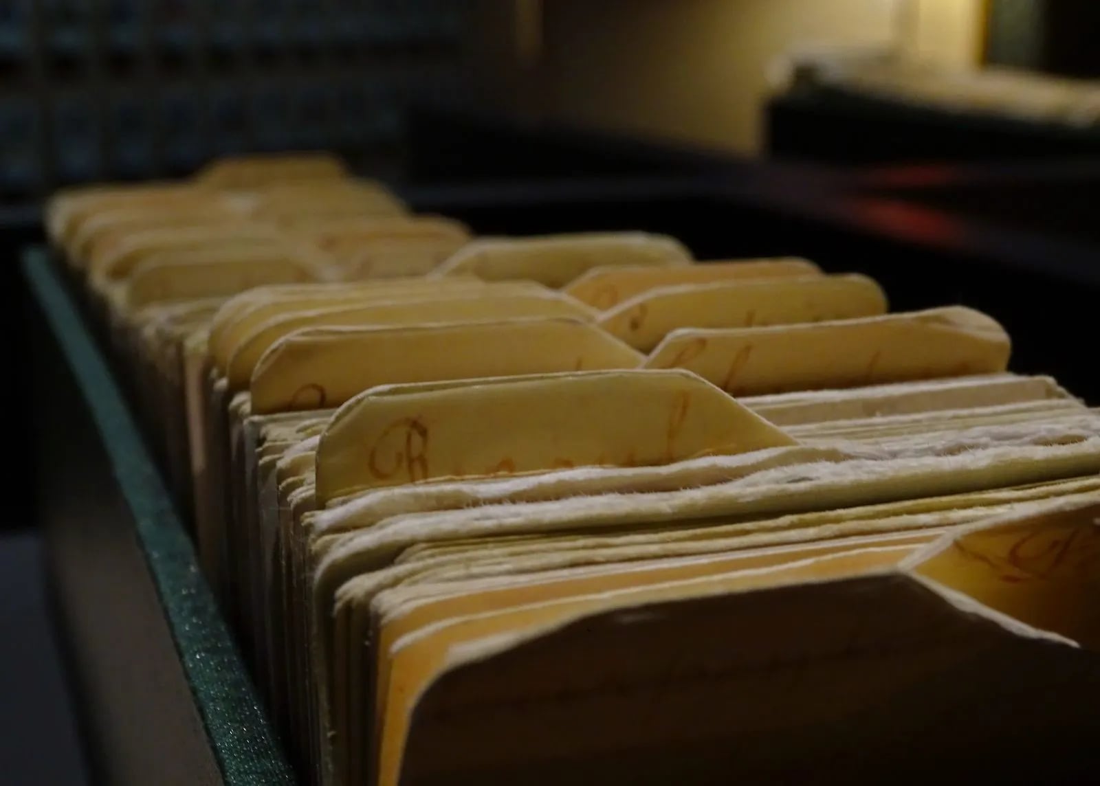 Vintage file folders organized in a row, representing records waiting to be organized into a table